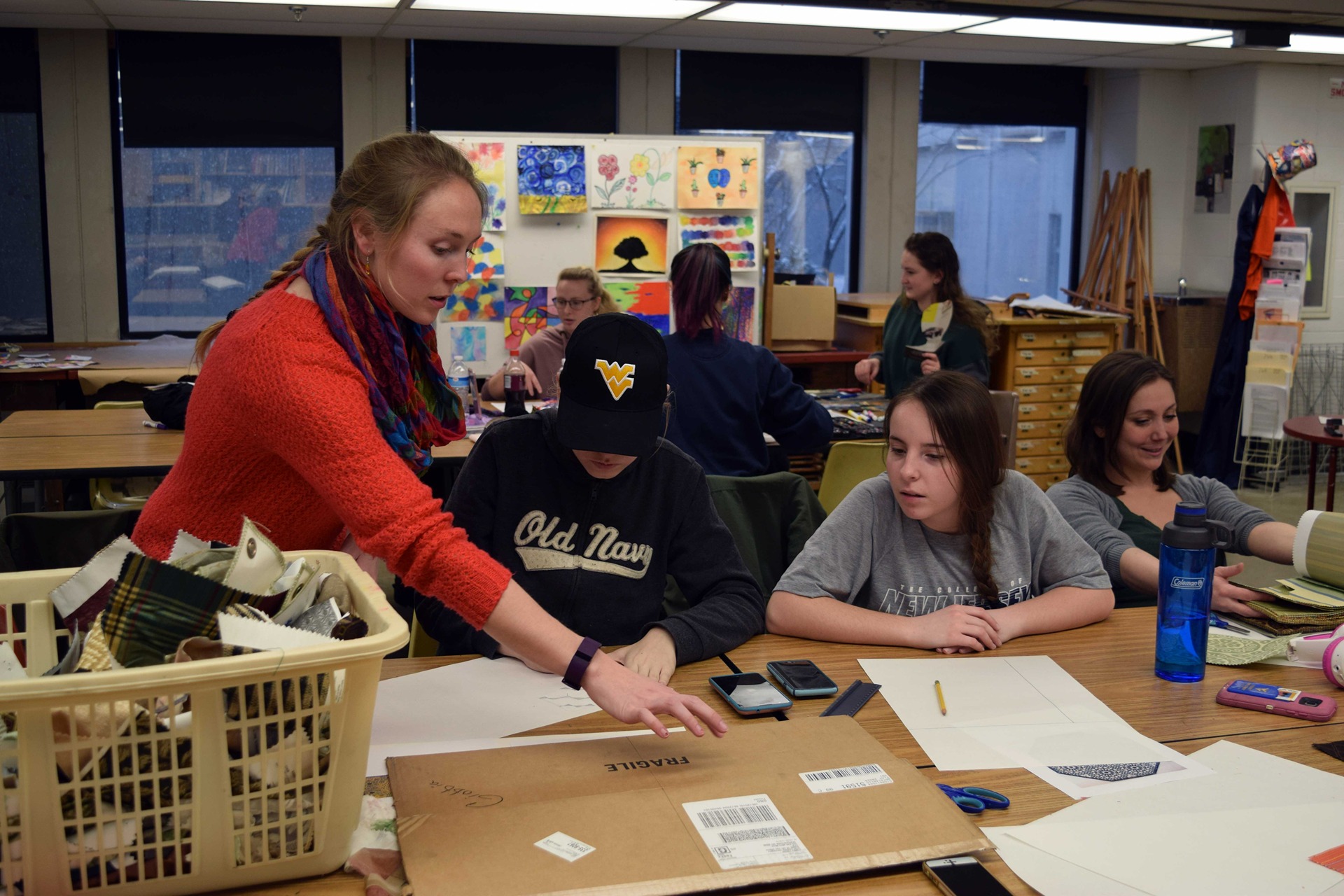 Student leading a classroom art activity.