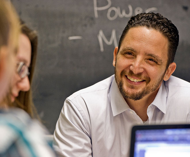 Instructor and students having a casual conversation in a classroom