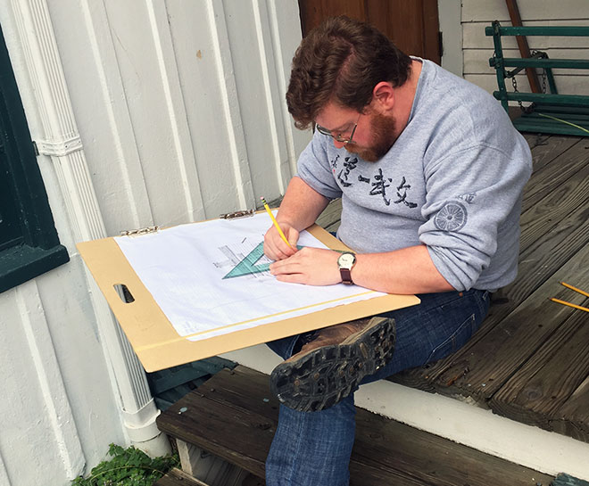 Person using a quick square to make a sketch.