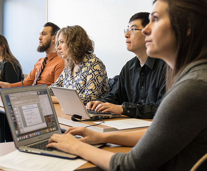 Students in classroom listen to a lecture.