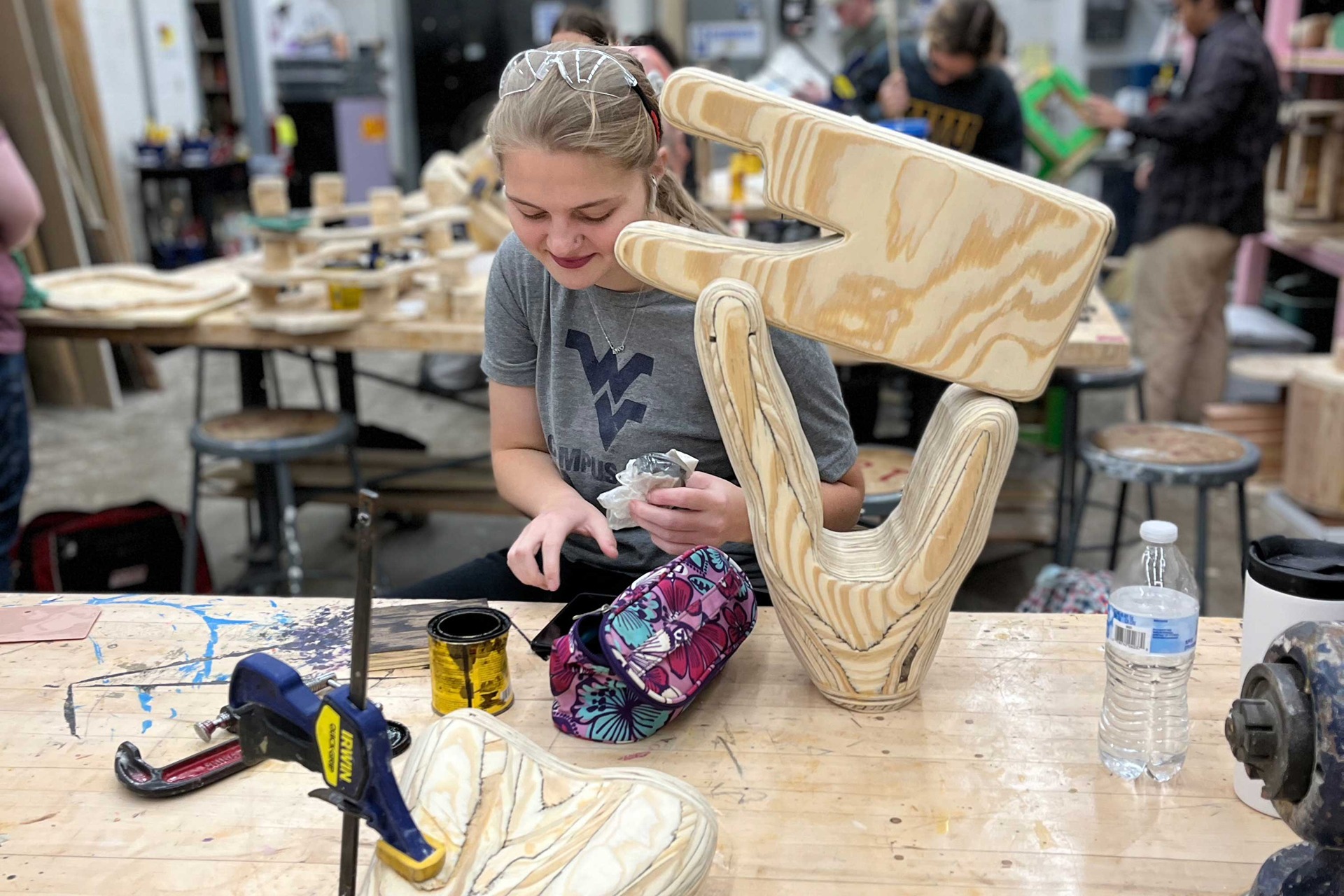 student making wood sculpture