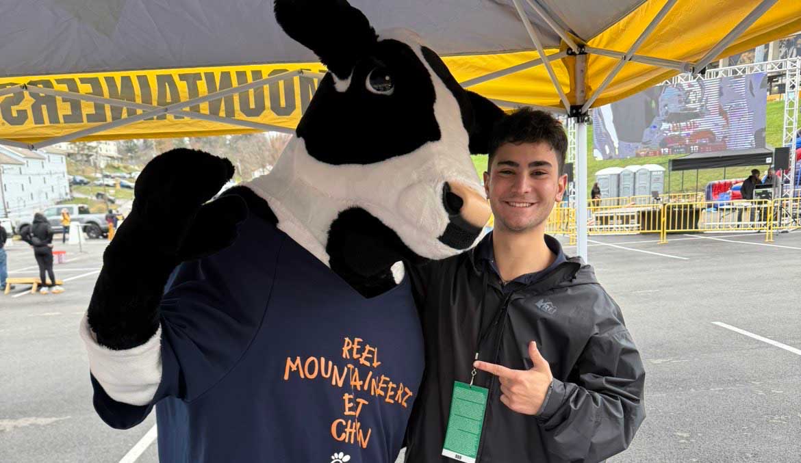 James Stamoulis points at the Chick-fil-A cow mascot