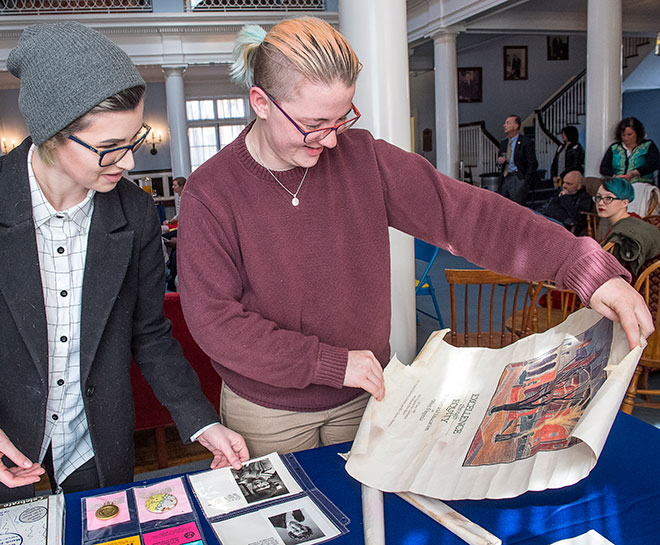 Students looking at archival photos