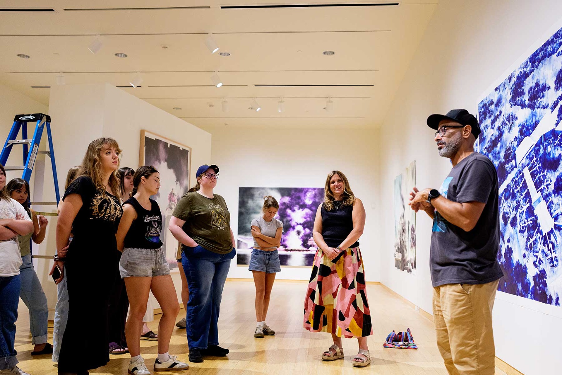 Artist Gamaliel Rodgriguez talks with Art History students about his exhibit, Topographies of Memory