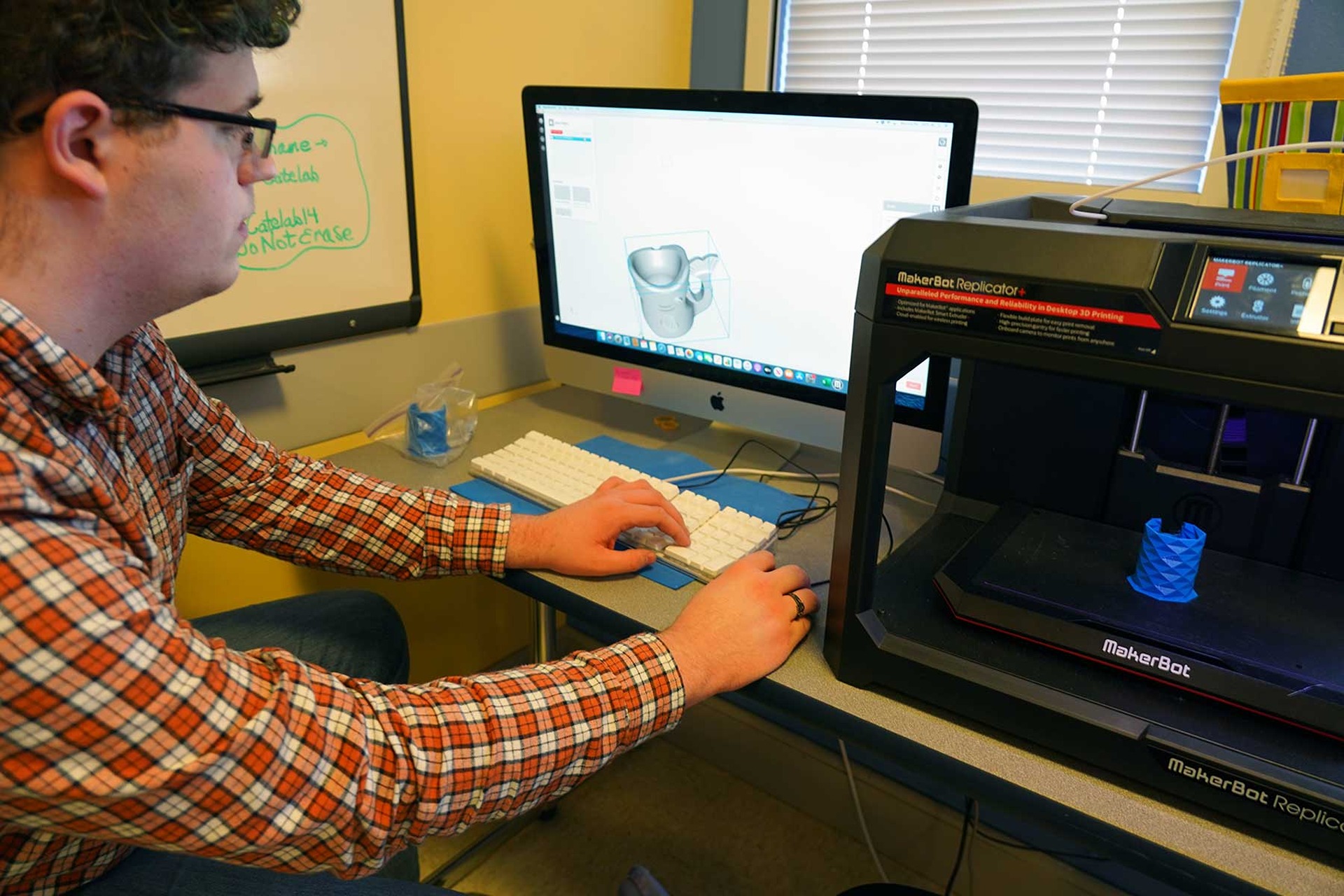 Person working with a 3D printer