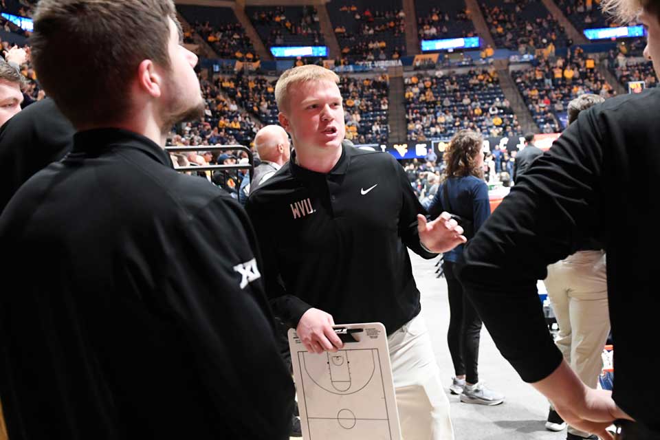 WVU basketball staff during a home game