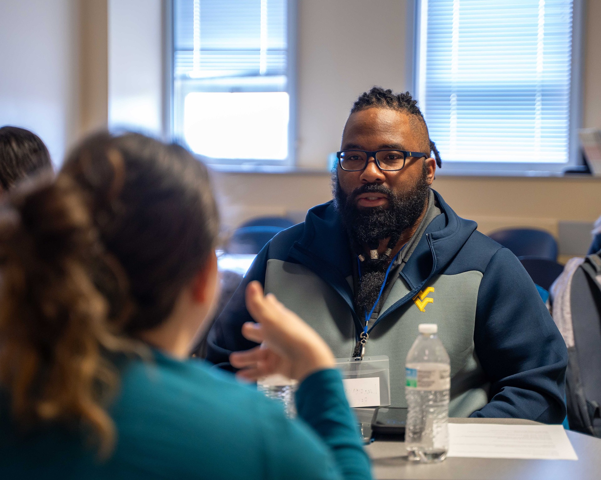 Two students talking in a classroom