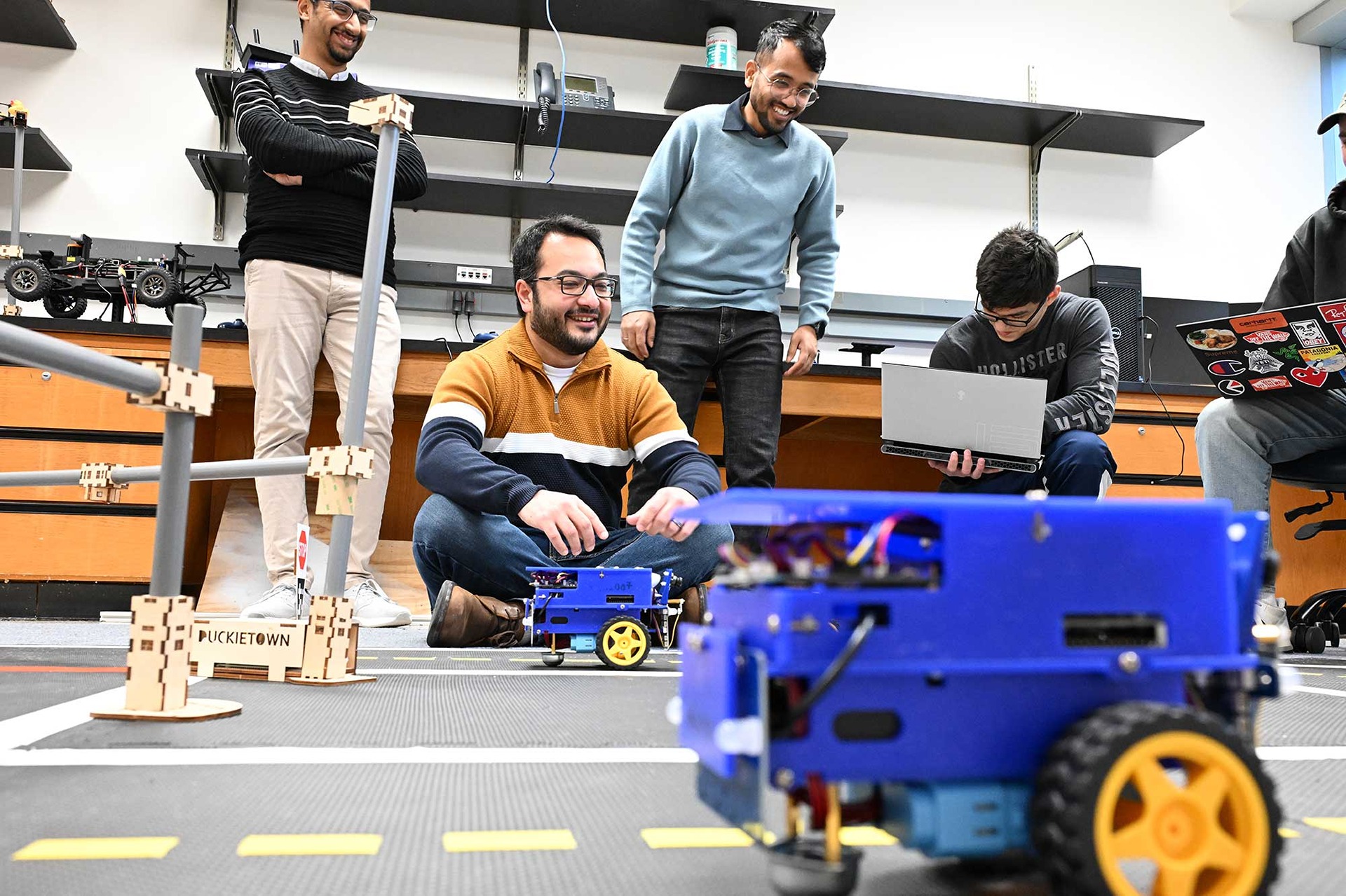 Assistant Professor Amr El-Wakeel and a group of students working on AI-driven autonomous vehicle navigation
