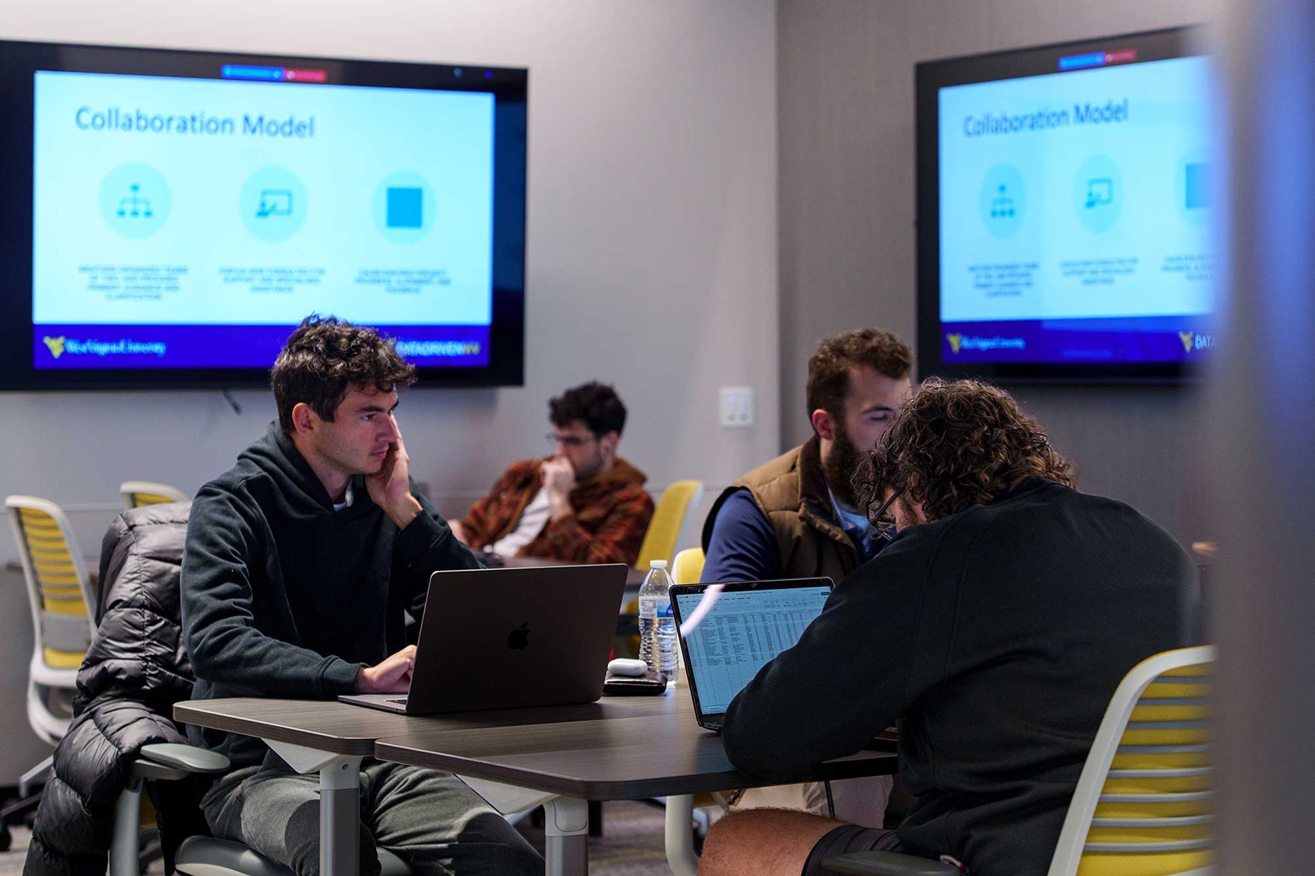 Students sitting at tables in the Data Analytics Lab