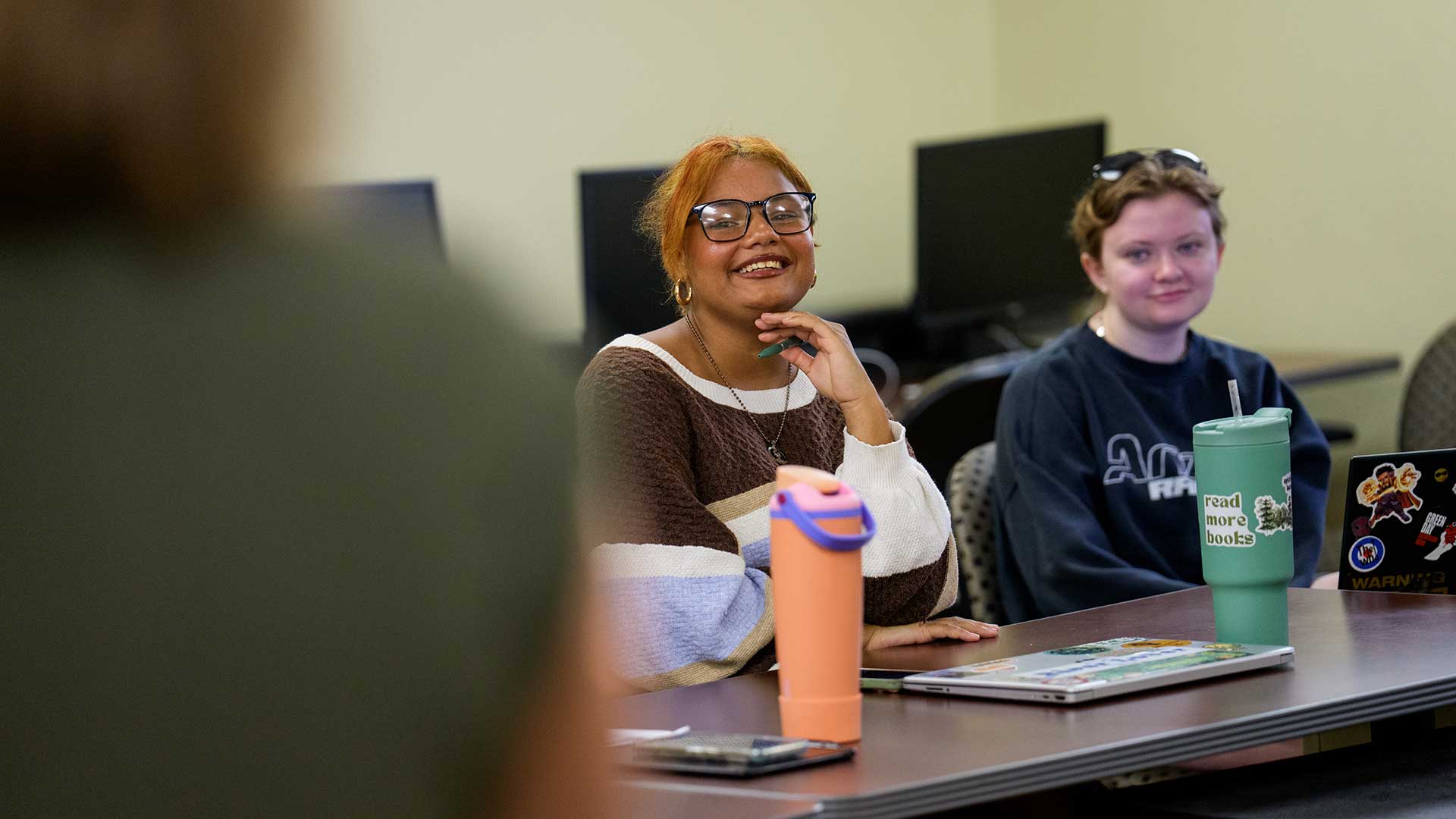 Students smiling during a writing class in Colson Hall