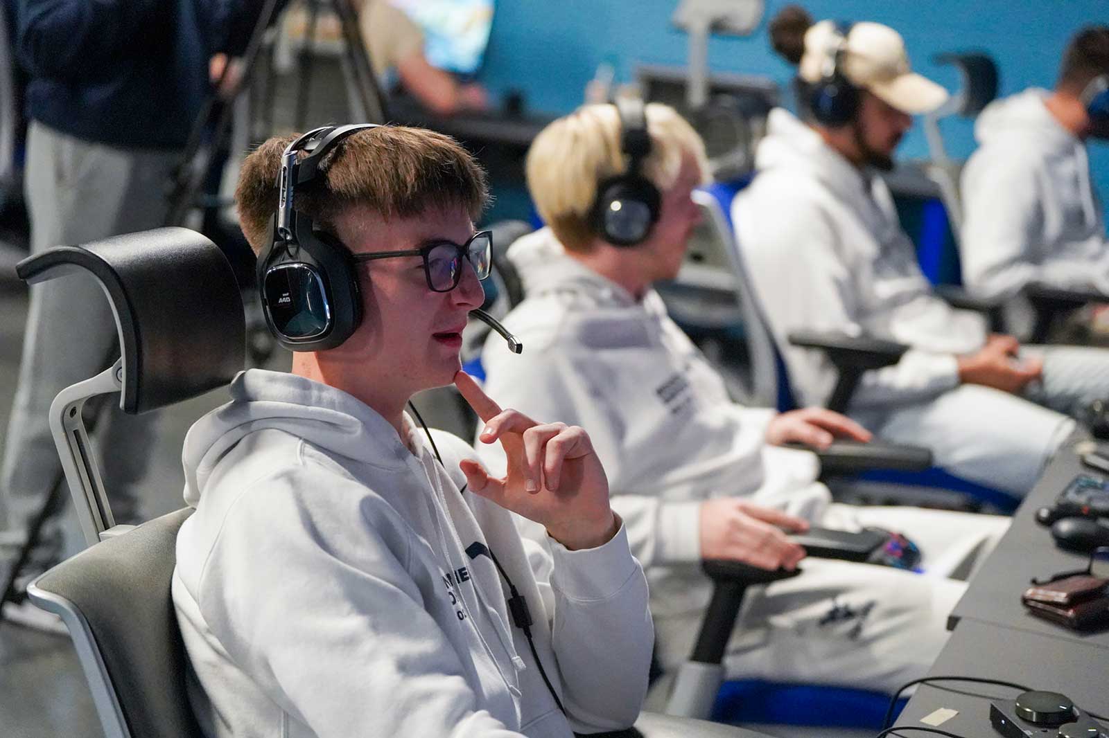 The varsity esports team talk to each other at the WVU Esports Facility.