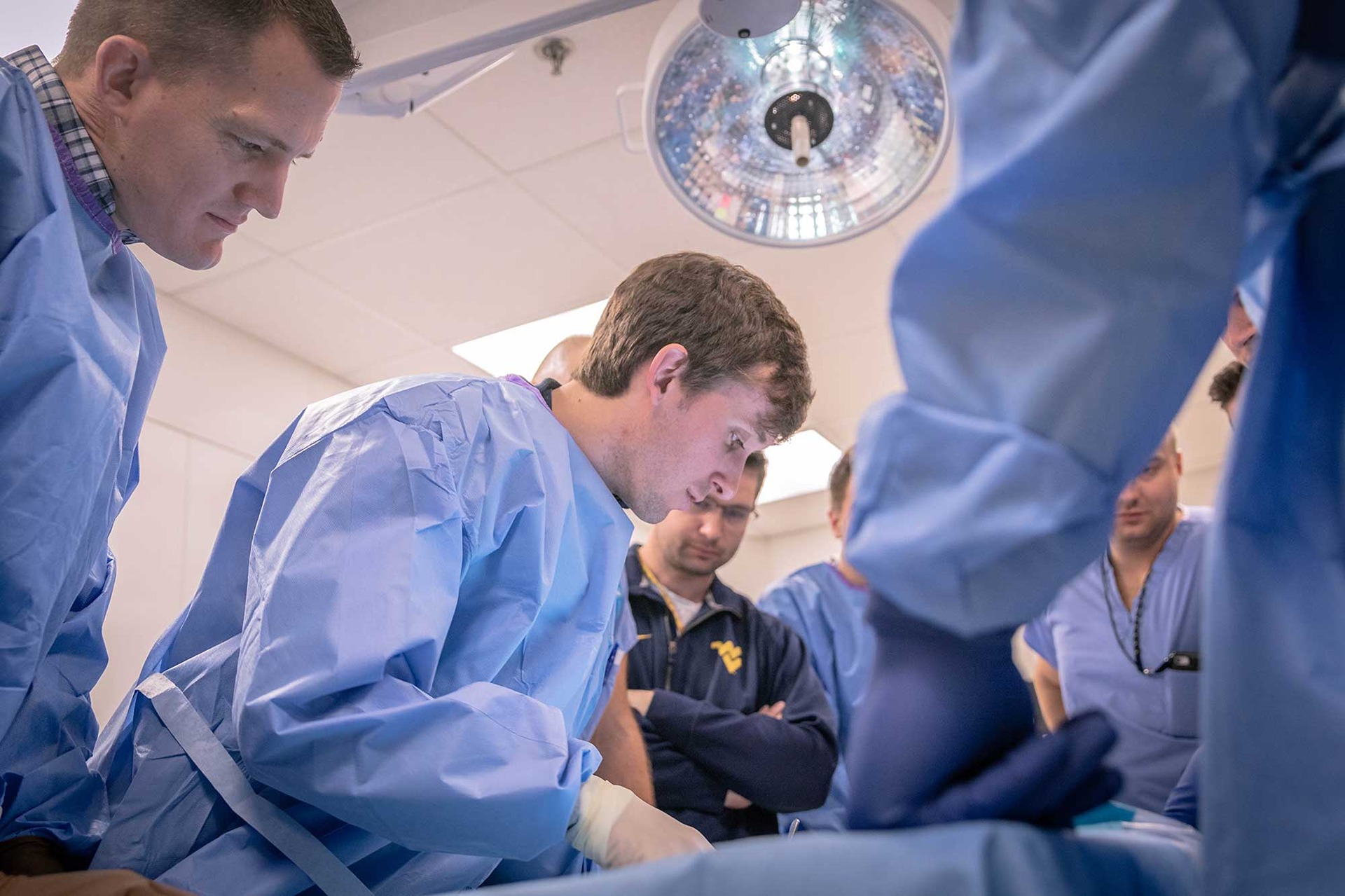 Orthopaedics residents inspect a cadaver in the Gross Anatomy Lab