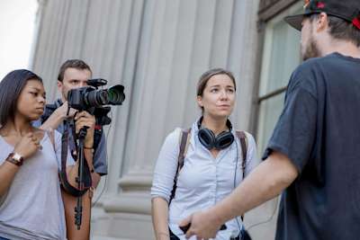 Student journalists interview a subject on camera in Baletimore
