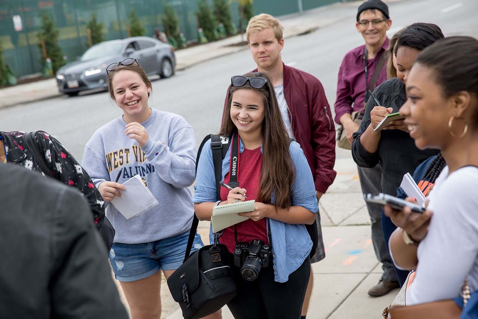 Students taking notes in notebooks