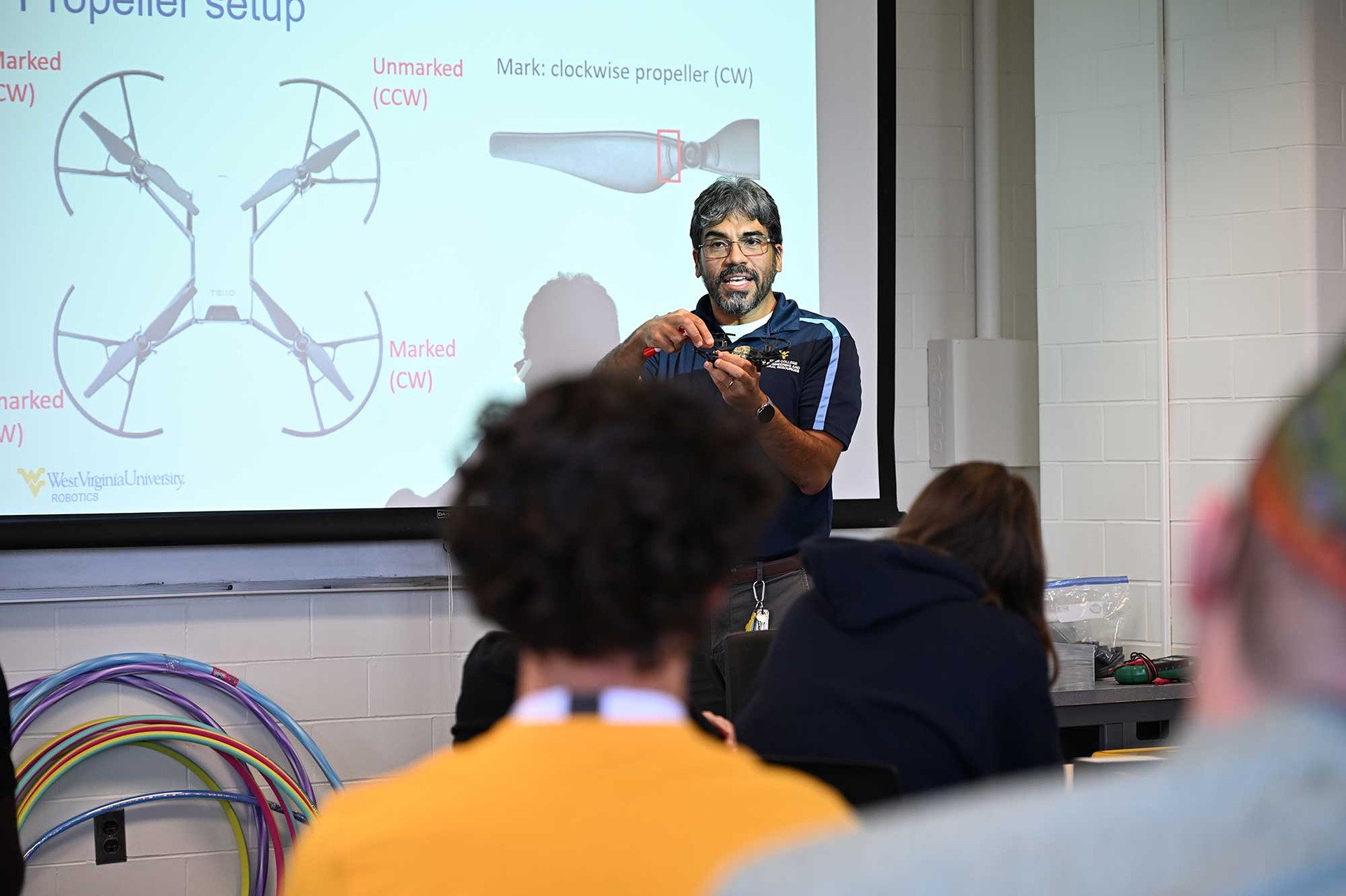 Teacher giving a presentation during a drone workshop for freshmen.