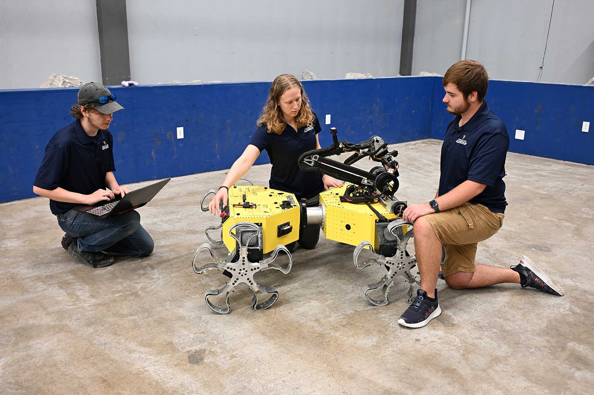 Three students working on a robot