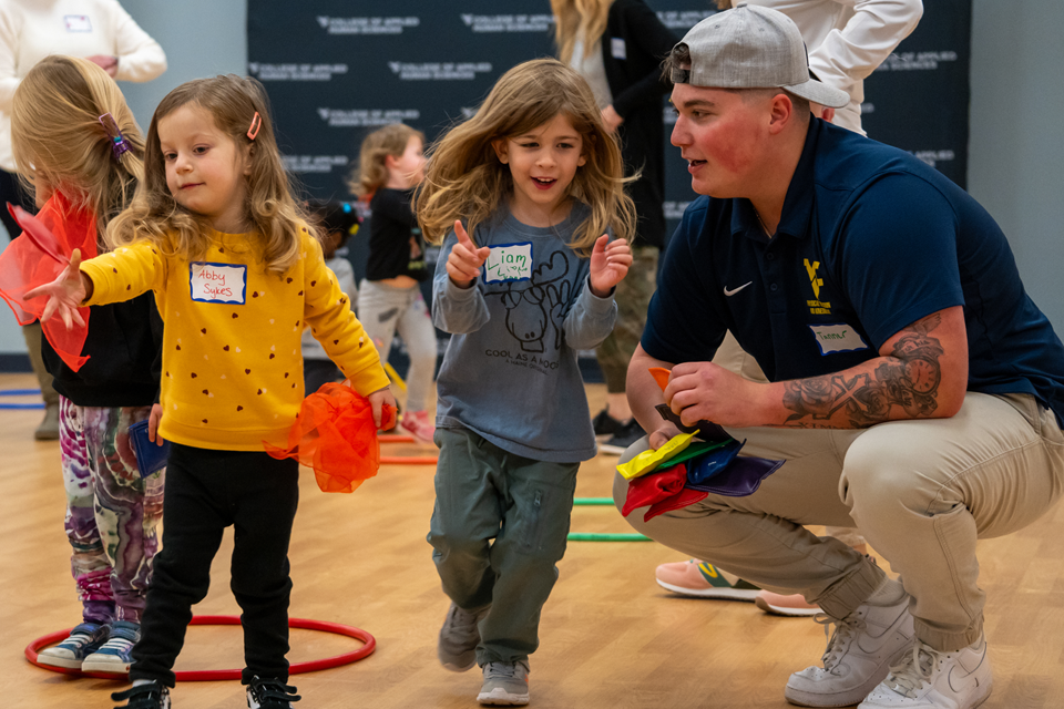 Student leads activity for group of Nursery School children
