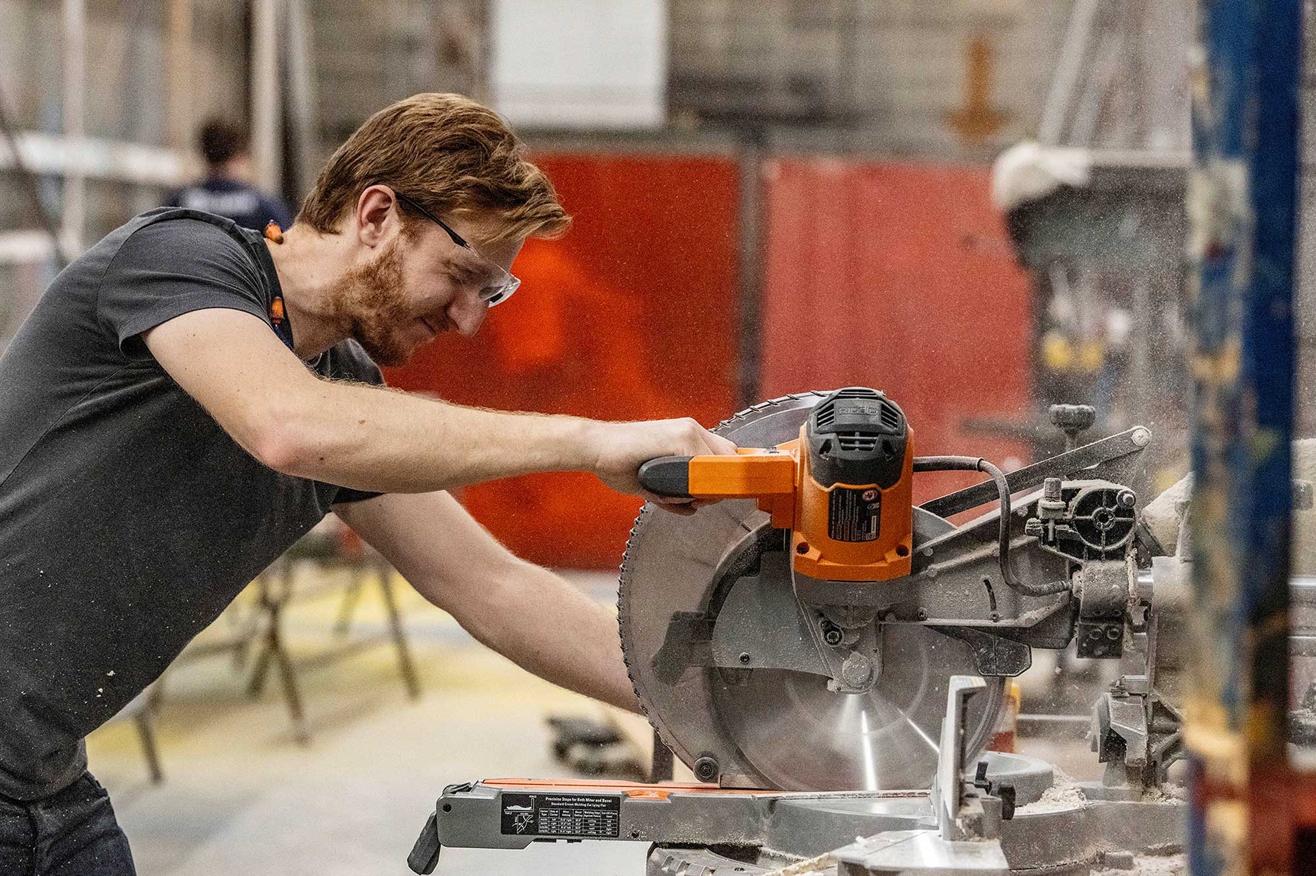 Student using a saw in the scene shop