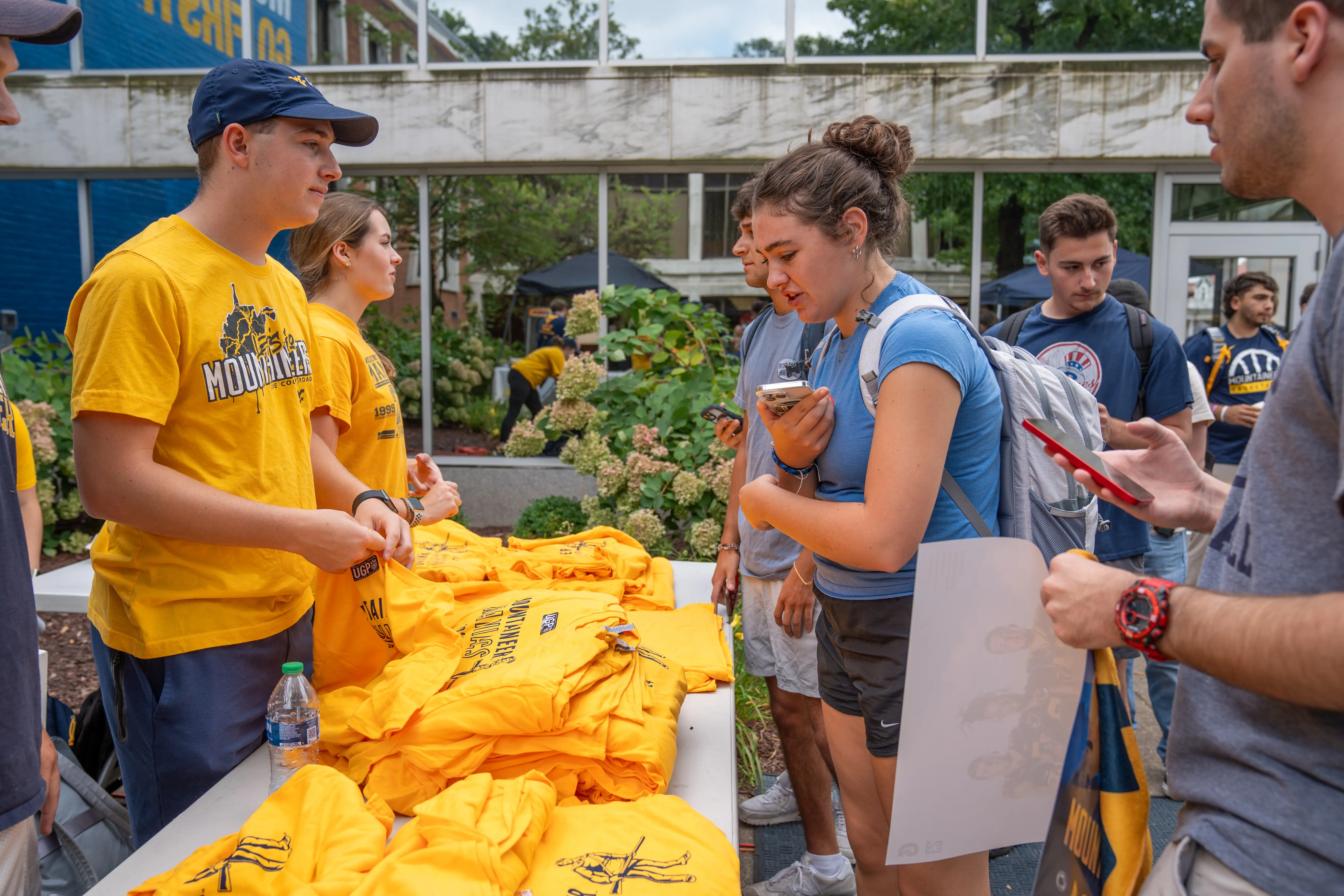 Students claiming their Mountaineer Maniac T-shirts at Mountaineer Friday