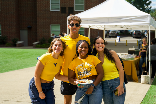 Four students enjoying the Student Lot during a home game.