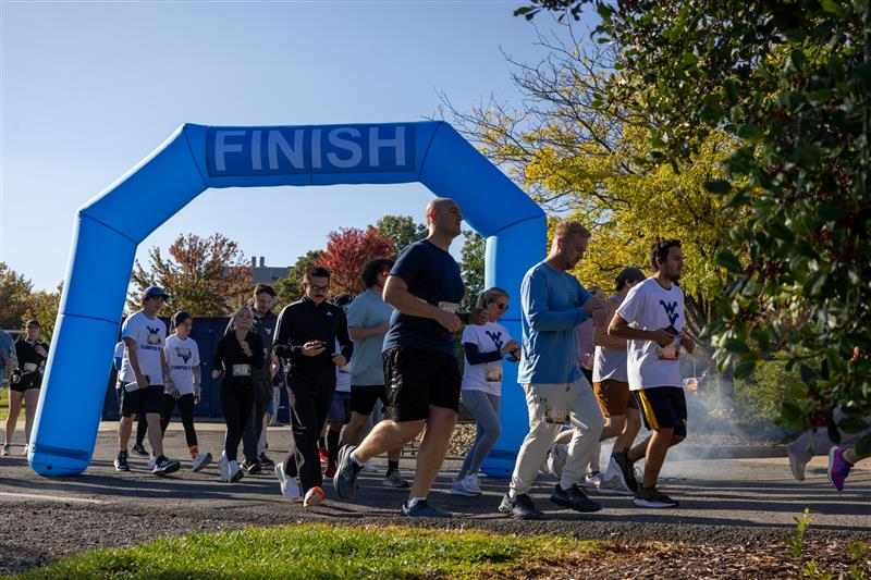 Students crossing the finish line at the 5th Annual Trick-or-trot 5k Run