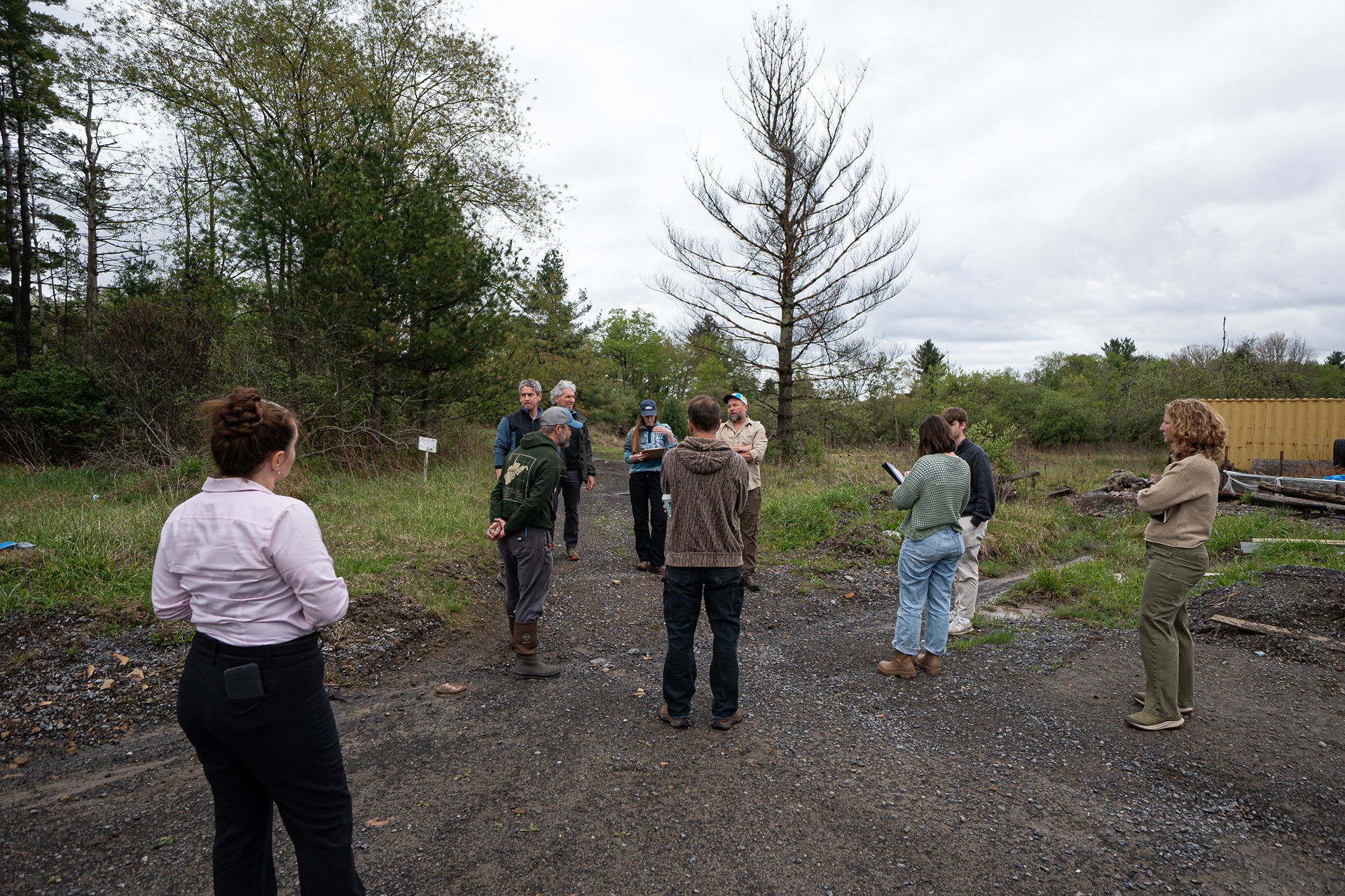 Thriving Communities partners gather at an outdoor project site.