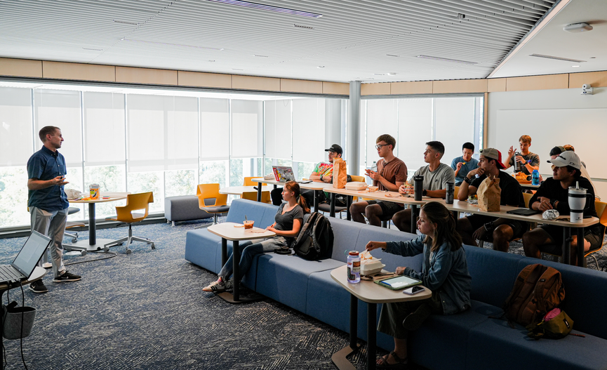 Vantage Ventures participants listen to a speaker during a classroom workshop.