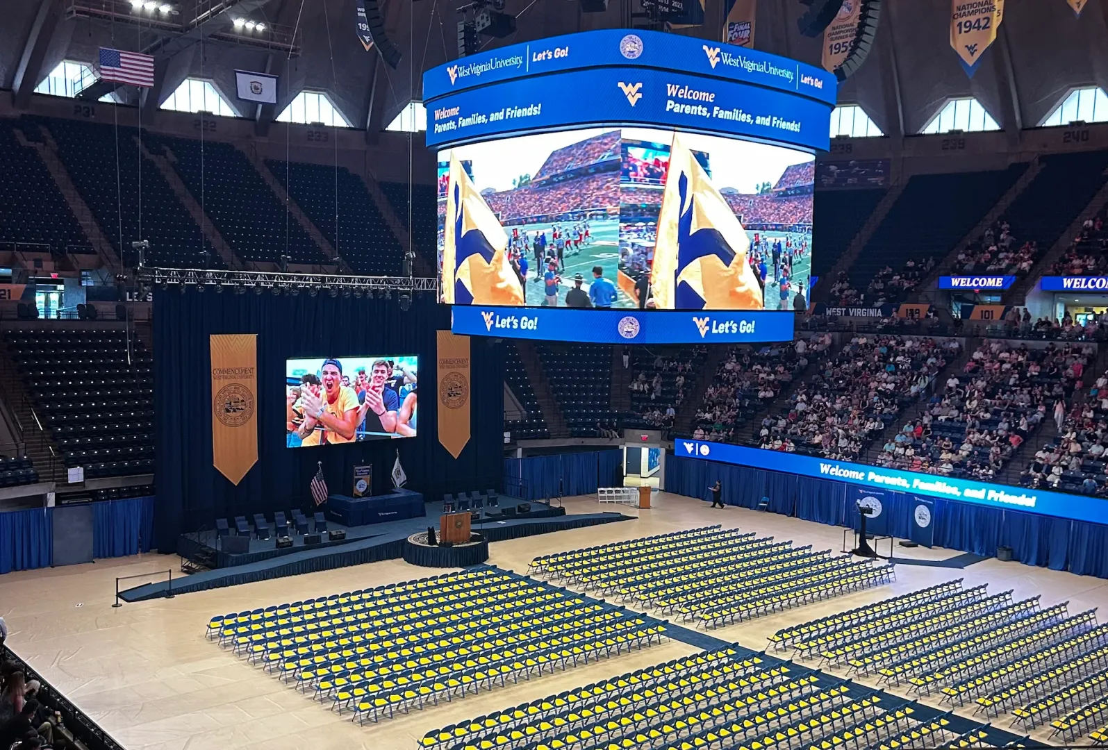 A celebratory video is playing on the screen at the Hope Colosseum before the graduates take their seats for the 2026 Commencement ceremony.